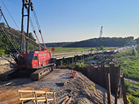 Crane at work site site overlooking bridge construction.